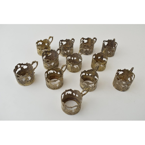 571 - A collection of white coloured metal (test as 800 silver or better) ornate cup holders, circa 155g+.