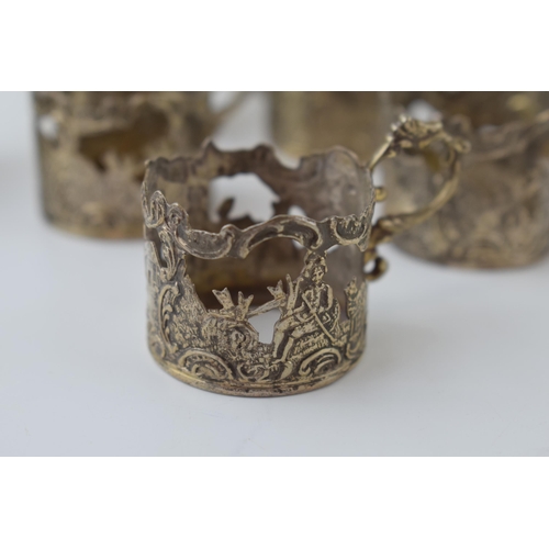 571 - A collection of white coloured metal (test as 800 silver or better) ornate cup holders, circa 155g+.