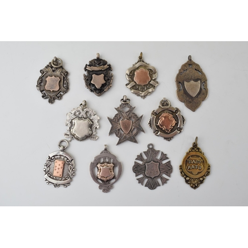 574 - A good collection of eleven silver fobs, 109.6g, some with gold plating, of varying themes and style... 