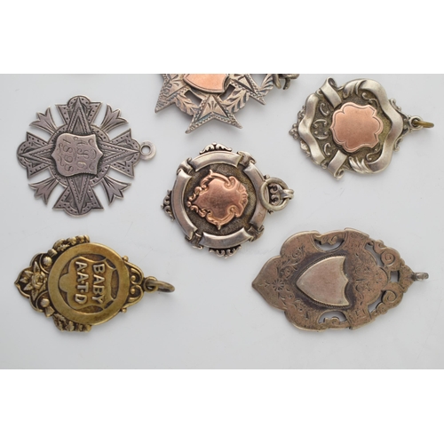 574 - A good collection of eleven silver fobs, 109.6g, some with gold plating, of varying themes and style... 