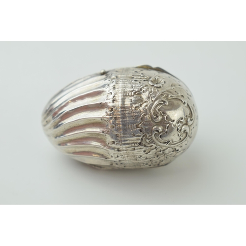 581 - A silver nut-shaped storage capsule for spice / nutmeg etc with repousse decoration and continental ... 