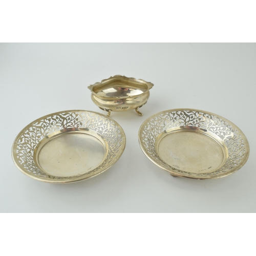 584 - A pair of silver sweet dishes, pierced edge decoration, raised on three bun feet, Birm, with a silve... 