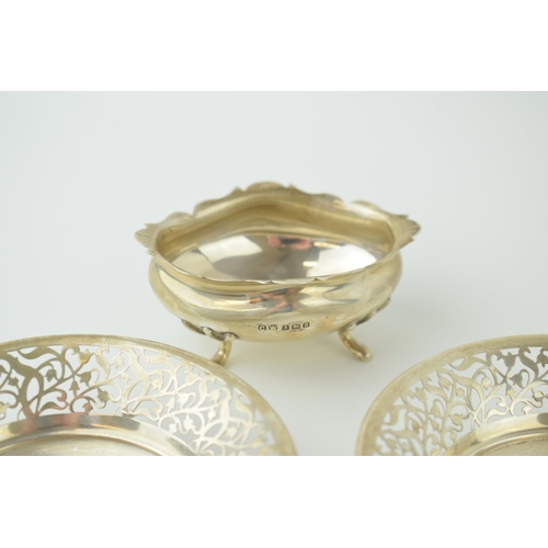 584 - A pair of silver sweet dishes, pierced edge decoration, raised on three bun feet, Birm, with a silve... 