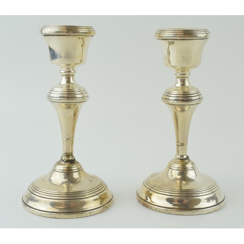 592 - A pair of silver candlesticks, loaded with high shoulder, 14cm tall (2), Birmingham 1952 (both been ... 