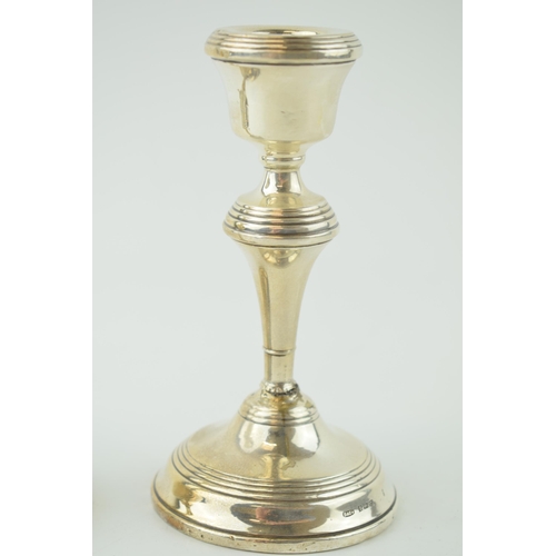 592 - A pair of silver candlesticks, loaded with high shoulder, 14cm tall (2), Birmingham 1952 (both been ... 