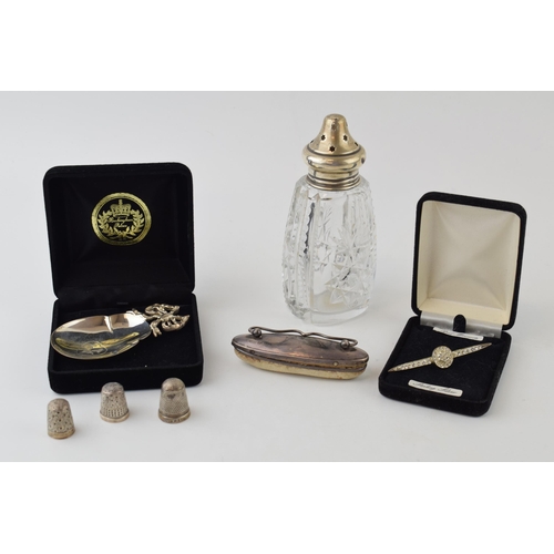 593 - A collection of hallmarked silver items to include a silver topped sugar sifter, three silver thimbl... 