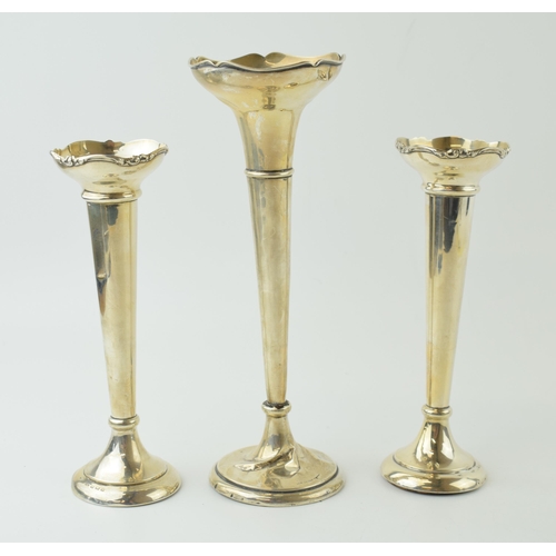 597 - A pair of loaded silver bud vases, ornate rims, 18cm tall, Birmingham 1919, with a larger bud vase, ... 