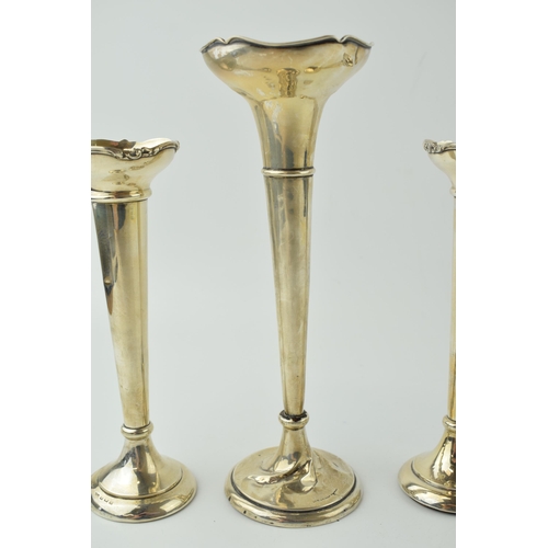 597 - A pair of loaded silver bud vases, ornate rims, 18cm tall, Birmingham 1919, with a larger bud vase, ... 