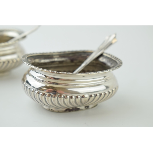 605 - A pair of silver table salts with spoons, without liners, Sheffield 1897, 107.3g.