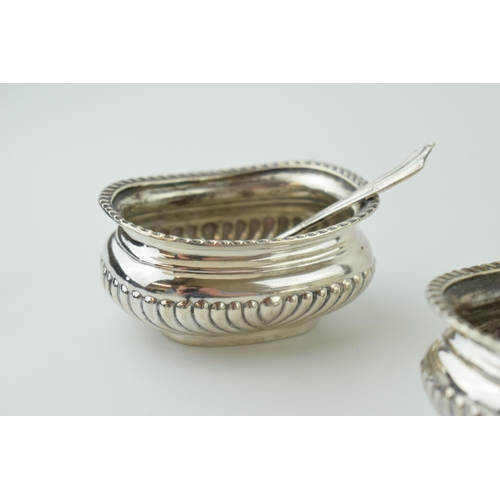 605 - A pair of silver table salts with spoons, without liners, Sheffield 1897, 107.3g.