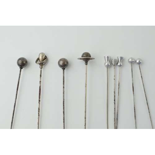 608 - A collection of hatpins to include two ornate silver examples and other white metal examples (9).