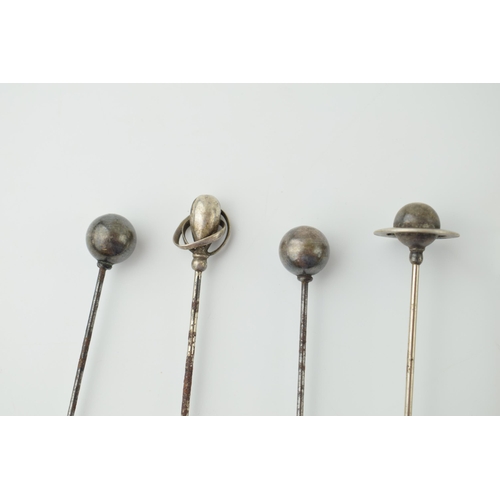 608 - A collection of hatpins to include two ornate silver examples and other white metal examples (9).