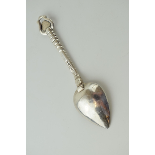 635 - An Arts and Crafts silver spoon, by Winifred King & Co, Birmingham 1934, with a hammered and pointed... 