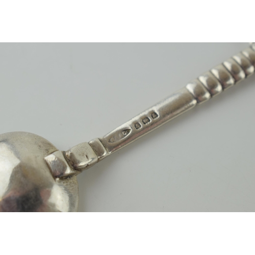 635 - An Arts and Crafts silver spoon, by Winifred King & Co, Birmingham 1934, with a hammered and pointed... 