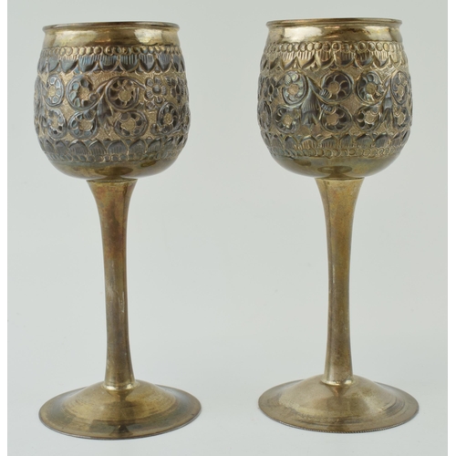 649 - A pair of silver goblets, on slim necks, with engraved floral decoration, of Eastern origin, 405.1g ... 