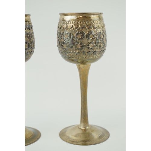 649 - A pair of silver goblets, on slim necks, with engraved floral decoration, of Eastern origin, 405.1g ... 