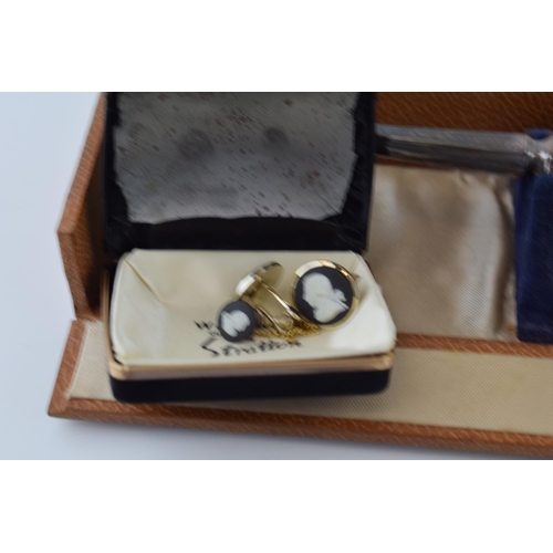 650 - A cased silver brush with traditional design, with a similar hand mirror and Wedgwood Jasperware cuf... 