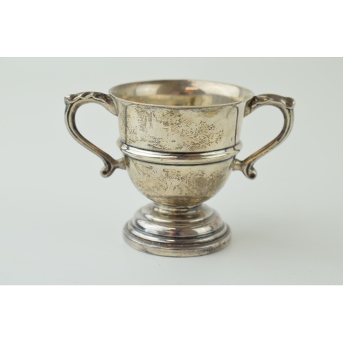 653 - Silver miniature two handled trophy, 61.8g, Dublin hallmark, stamped Weir & Sons.