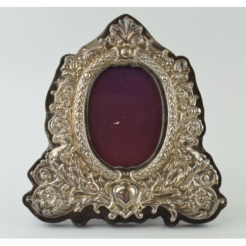 663 - Hallmarked silver ornate photo frame with easel-back, with oval insert, 22.5cm tall, indistinct hall... 