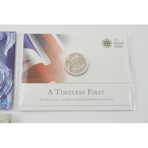 685 - A collection of carded silver coins to include George & the Dragon £20 fine silver coin, 15.71g, 201... 