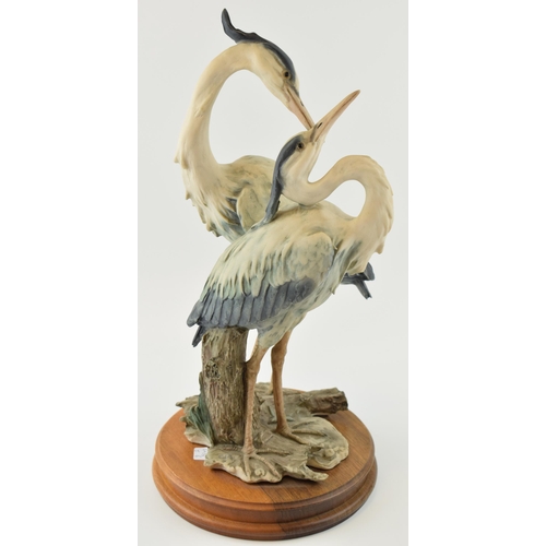 112 - Capo Di Monte figural pair of two herons standing, 42cm tall.