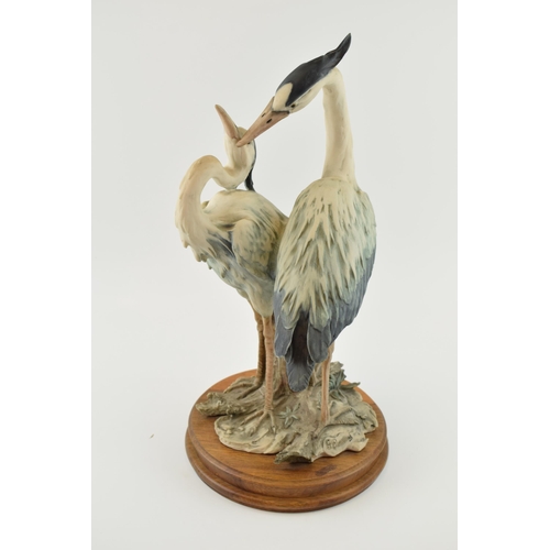 112 - Capo Di Monte figural pair of two herons standing, 42cm tall.