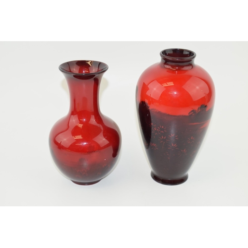 184 - A pair of Royal Doulton flambe vases to include a low shouldered vase with a similar one, rural scen... 