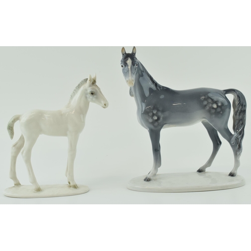 27 - A pair of continental pottery horse figures to include a dappled grey example facing left by Metzleh... 