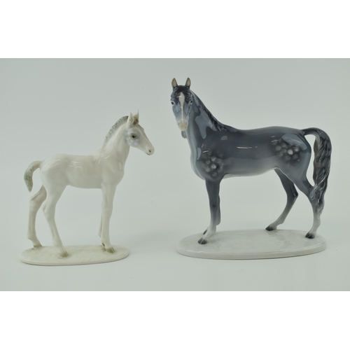 27 - A pair of continental pottery horse figures to include a dappled grey example facing left by Metzleh... 