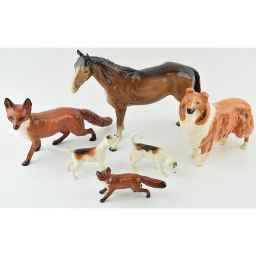41 - Beswick to include a large standing fox, two foxhounds, a small standing fox, a rough collie and a b... 