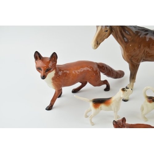 41 - Beswick to include a large standing fox, two foxhounds, a small standing fox, a rough collie and a b... 