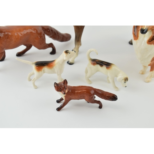 41 - Beswick to include a large standing fox, two foxhounds, a small standing fox, a rough collie and a b... 