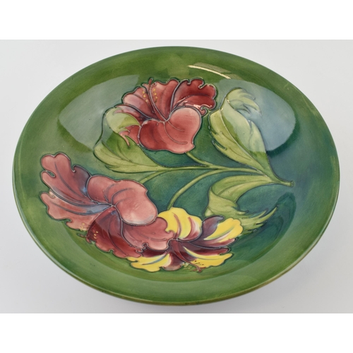 71 - Moorcroft Hibiscus on green bowl, 24.5cm diameter.