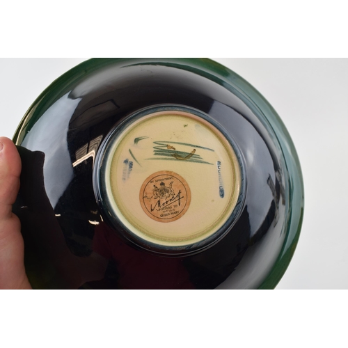 71 - Moorcroft Hibiscus on green bowl, 24.5cm diameter.