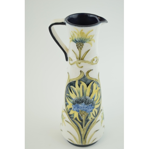 73 - A pottery Ewer, in the style of Moorcroft Florian ware, 25cm tall, impressed marks to base.