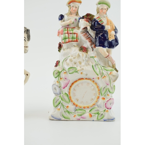 76 - A pair of Staffordshire flatbacks to include a Scottish couple with a goat above a clock and the Duk... 