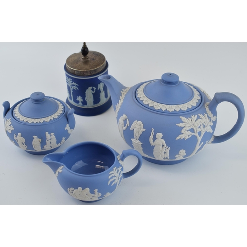 299 - Wedgwood Jasperware in blue to include a teapot, cream jug and sugar bowl with a dip blue sugar jar ... 