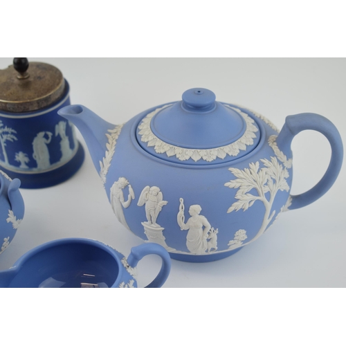 299 - Wedgwood Jasperware in blue to include a teapot, cream jug and sugar bowl with a dip blue sugar jar ... 