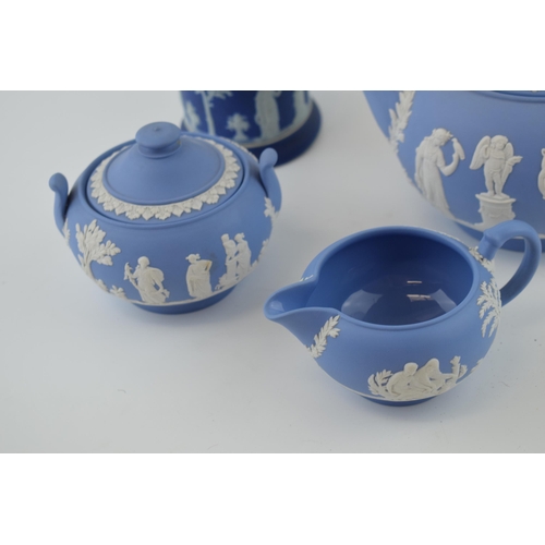 299 - Wedgwood Jasperware in blue to include a teapot, cream jug and sugar bowl with a dip blue sugar jar ... 