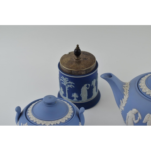 299 - Wedgwood Jasperware in blue to include a teapot, cream jug and sugar bowl with a dip blue sugar jar ... 