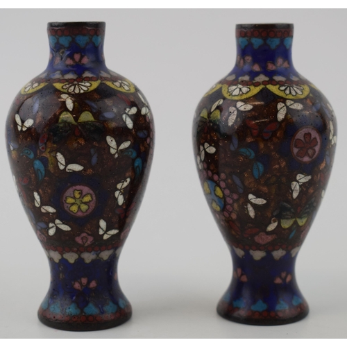 334 - A small pair of cloisonné high shouldered vases, decorated with butterflies and flowers, 9.5cm tall.