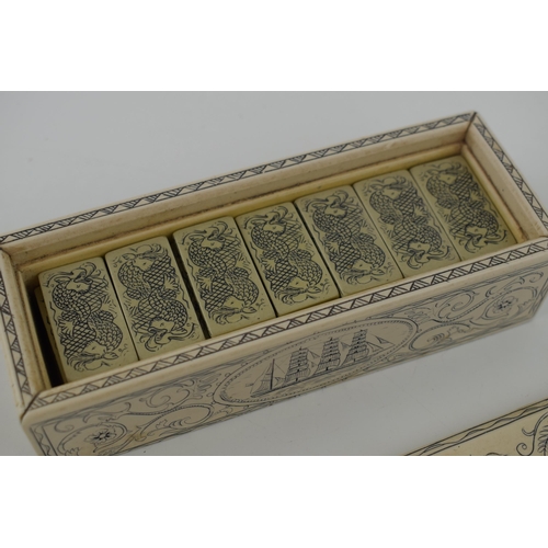 335 - A set of dominoes in case with scrimshaw style decoration. 17cm.