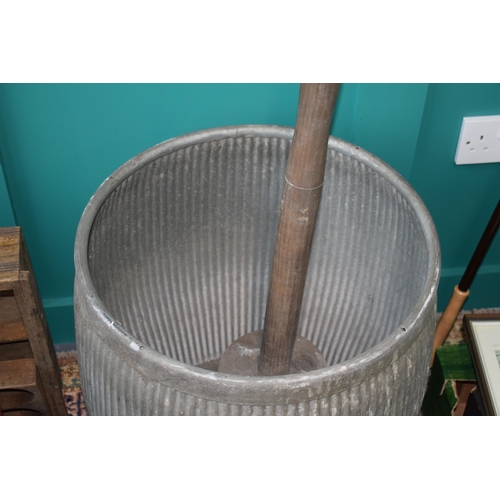 340 - A vintage galvanised dolly tub with original wooden dolly. Height 54cm.