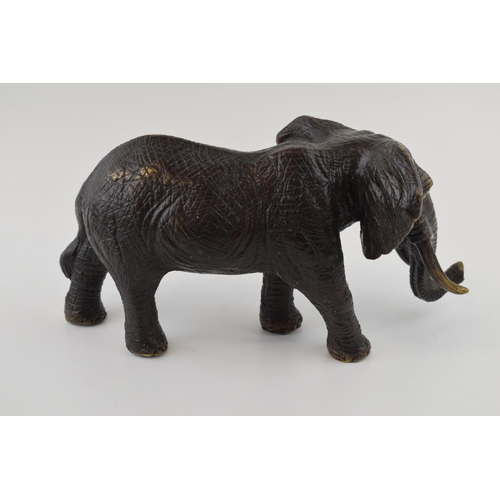 366 - Large contemporary bronzed figure of a walking elephant, with two tusks, 30cm long.