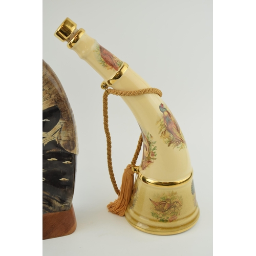 379 - Spirit of Robin Hoode pottery decanter in the form of a horn, with a carved horn with eagle design (... 