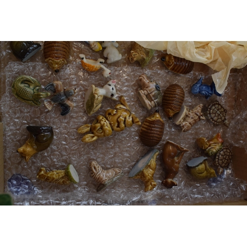 673 - A collection of ceramic items to include Wade Whimseys, miniature glass items, together with other W... 