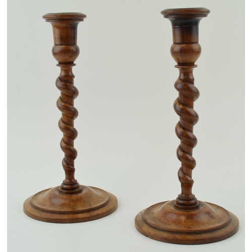 440 - A pair of 19th century olive wood turned candlesticks, weighted bases, 23cm tall.