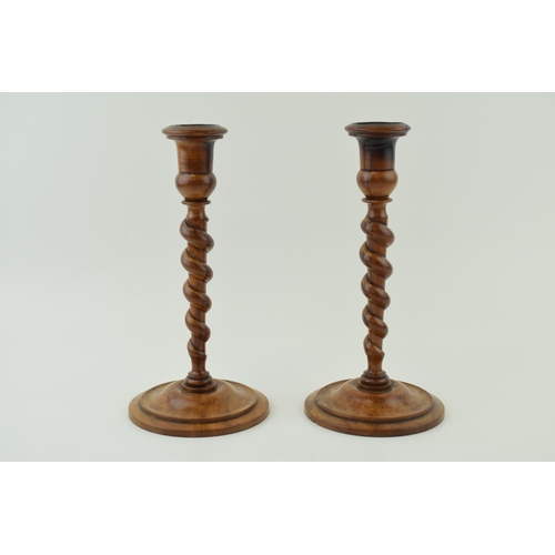 440 - A pair of 19th century olive wood turned candlesticks, weighted bases, 23cm tall.