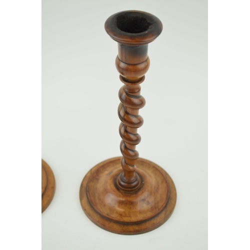 440 - A pair of 19th century olive wood turned candlesticks, weighted bases, 23cm tall.