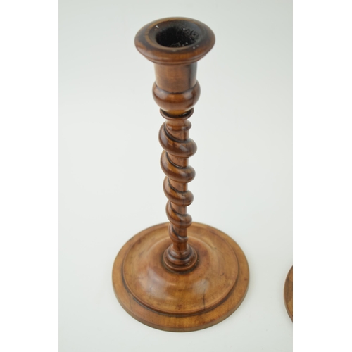 440 - A pair of 19th century olive wood turned candlesticks, weighted bases, 23cm tall.